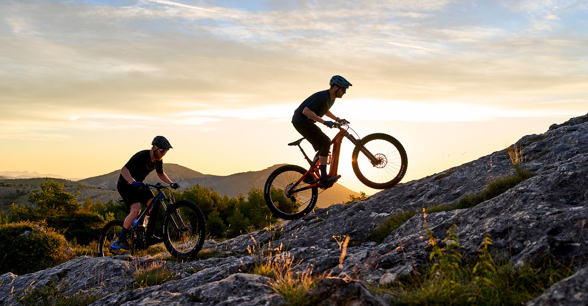 Mountain biker climbing on electric bike